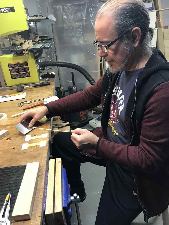 Jose Rios Nebro thining strips to make the mosaic blocks for a rosette